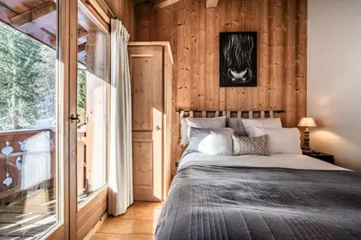 a bedroom with a bed and a large window at Chalet Olea Chamonix - by EMERALD STAY in Chamonix-Mont-Blanc