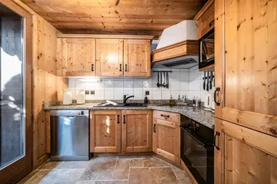 a kitchen with wooden cabinets and a sink at Chalet Olea Chamonix - by EMERALD STAY in Chamonix-Mont-Blanc