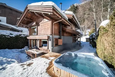 a hot tub in the snow in front of a house at Chalet Olea Chamonix - by EMERALD STAY in Chamonix-Mont-Blanc