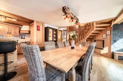 a dining room with a wooden table and chairs at Chalet Olea Chamonix - by EMERALD STAY in Chamonix-Mont-Blanc