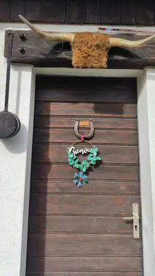 a wooden garage door with a sign on it at A Cordon entre Bois et Nature in Cordon