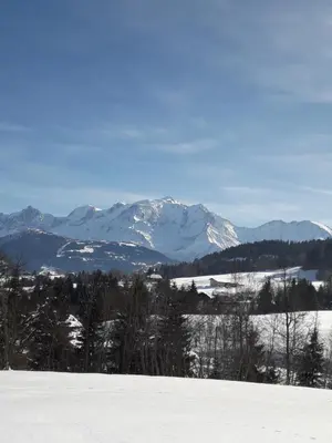 a snowy mountain range with snow covered mountains in the distance at A Cordon entre Bois et Nature in Cordon