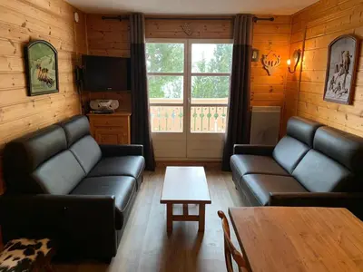 a living room with leather couches and a table at Duplex Confortable 3P - 6/8 Pers - Balcon - FR-1-425-127 in Arâches-la-Frasse
