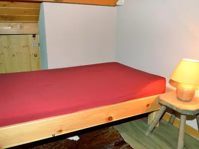 a small bed with a red mattress in a room at Duplex Confortable 3P - 6/8 Pers - Balcon - FR-1-425-127 in Arâches-la-Frasse