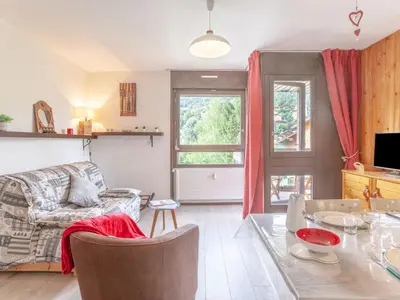 a living room with a table and a couch at Apartment Castel des Roches B20 by Interhome in Saint-Gervais-les-Bains