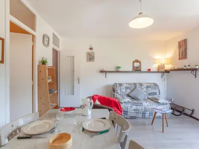 a dining room with a table and a couch at Apartment Castel des Roches B20 by Interhome in Saint-Gervais-les-Bains