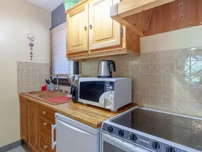 a kitchen with a microwave on top of a counter at Apartment Castel des Roches B20 by Interhome in Saint-Gervais-les-Bains