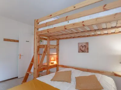 a bedroom with a wooden bunk bed with a ladder at Apartment Castel des Roches B20 by Interhome in Saint-Gervais-les-Bains