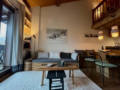 a living room with a couch and a table at Appartement ensoleillé aux Tines, vue Massif in Chamonix-Mont-Blanc