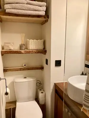 a bathroom with a toilet and a sink and towels at Appartement ensoleillé aux Tines, vue Massif in Chamonix-Mont-Blanc