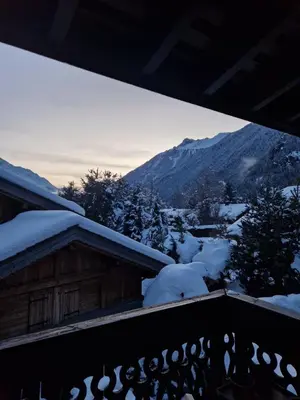 a view of a snow covered mountain from a balcony at Appartement ensoleillé aux Tines, vue Massif in Chamonix-Mont-Blanc