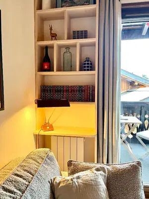a living room with a couch and a window at Appartement ensoleillé aux Tines, vue Massif in Chamonix-Mont-Blanc