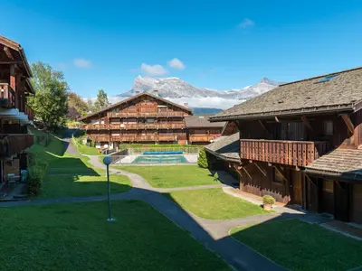 an aerial view of a resort with mountains in the background at Ski-in/ski-out & pool: great for summer and winter in Saint-Gervais-les-Bains