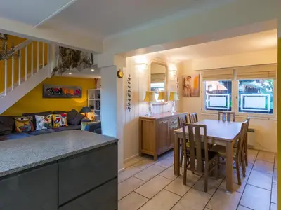 a kitchen and living room with a table and chairs at Ski-in/ski-out & pool: great for summer and winter in Saint-Gervais-les-Bains