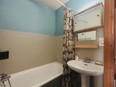 a bathroom with a sink and a bath tub at Studio cosy centre village, animaux acceptés, parking privé - FR-1-624-121 in Samoëns