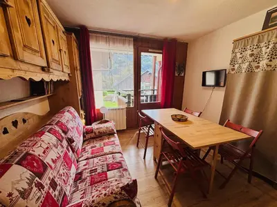 a living room with a couch and a table at Studio cosy centre village, animaux acceptés, parking privé - FR-1-624-121 in Samoëns