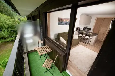 a view of a living room and kitchen from the balcony of a house at Charmant Studio tout confort au Brévent-Chamonix in Chamonix-Mont-Blanc