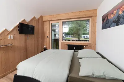 a bedroom with a large bed and a window at Charmant Studio tout confort au Brévent-Chamonix in Chamonix-Mont-Blanc
