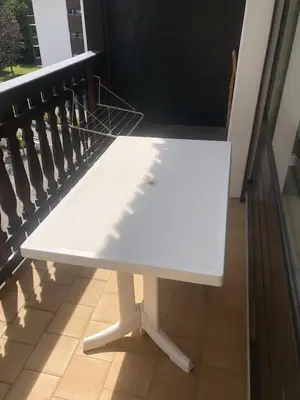 a white bench sitting on top of a balcony at Studio Les Carroz in Les Carroz d'Araches