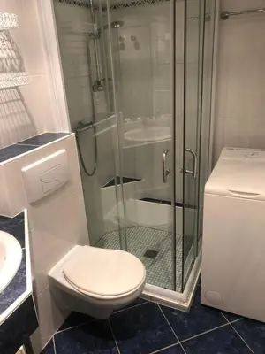 a bathroom with a toilet and a glass shower at Studio Les Carroz in Les Carroz d'Araches