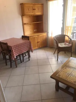 a dining room with a table and chairs and a table at Studio Les Carroz in Les Carroz d'Araches