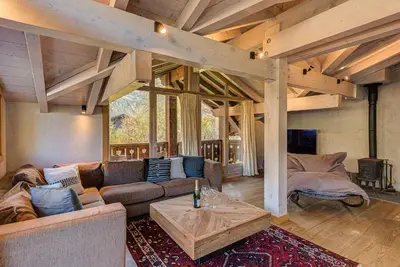 a living room with a couch and a table at Chalet Kaiya - Alpes Travel - Les Praz - sleeps 8 in Chamonix-Mont-Blanc
