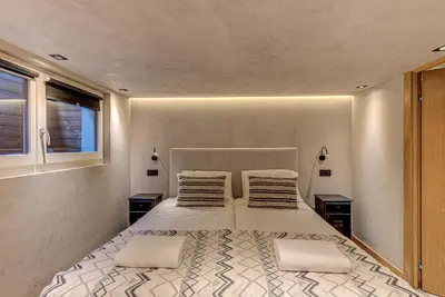 a bedroom with a large bed with two night stands at Chalet Kaiya - Alpes Travel - Les Praz - sleeps 8 in Chamonix-Mont-Blanc