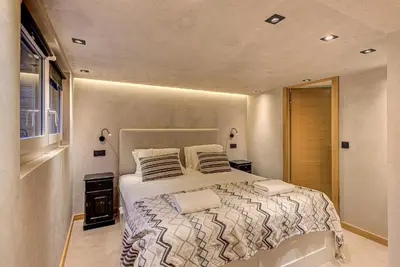 a bedroom with a large bed with two pillows at Chalet Kaiya - Alpes Travel - Les Praz - sleeps 8 in Chamonix-Mont-Blanc