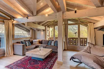 a living room with a couch and a table at Chalet Kaiya - Alpes Travel - Les Praz - sleeps 8 in Chamonix-Mont-Blanc