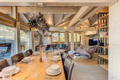 a dining room with a long table and chairs at Chalet Kaiya - Alpes Travel - Les Praz - sleeps 8 in Chamonix-Mont-Blanc