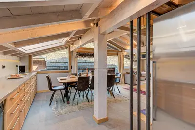 a kitchen and dining room with a table and chairs at Chalet Kaiya - Alpes Travel - Les Praz - sleeps 8 in Chamonix-Mont-Blanc
