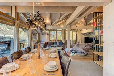 a dining room with a long table and chairs at Chalet Kaiya - Alpes Travel - Les Praz - sleeps 8 in Chamonix-Mont-Blanc