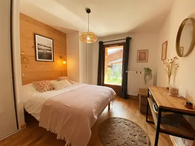 a bedroom with a bed and a table and a window at Charmant T3 Neuf, Skibus Gratuit, Terrasse, 2 Places Privées, WIFI - Samoëns - FR-1-624-122 in Samoëns