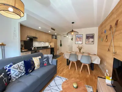 a living room with a couch and a table at Charmant T3 Neuf, Skibus Gratuit, Terrasse, 2 Places Privées, WIFI - Samoëns - FR-1-624-122 in Samoëns
