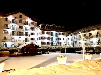 a group of buildings at night with snow at Exceptionnel duplex en Residence & Spa Vallorcine Mont-Blanc 5 étoiles in Vallorcine