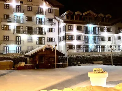 a large building with snow in front of it at night at Exceptionnel duplex en Residence & Spa Vallorcine Mont-Blanc 5 étoiles in Vallorcine