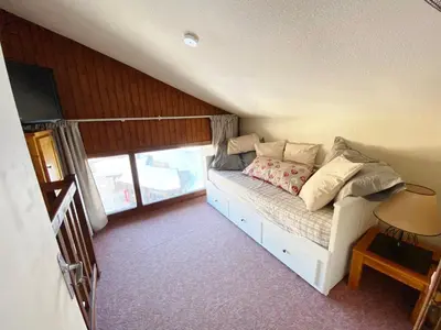 a bedroom with a mirror and a bed in a room at Appartement 2 pièces avec mezzanine près des pistes - 6 personnes - FR-1-815-81 in Morillon