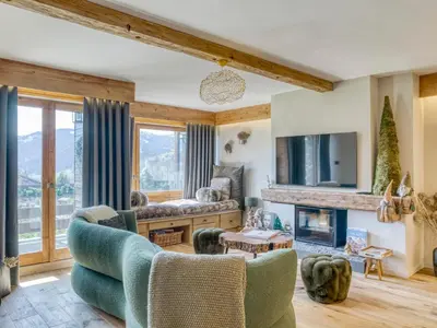 a living room with a couch and a fireplace at Charmant appartement 2 chambres avec cheminée et parking à Megève - FR-1-453-254 in Megève