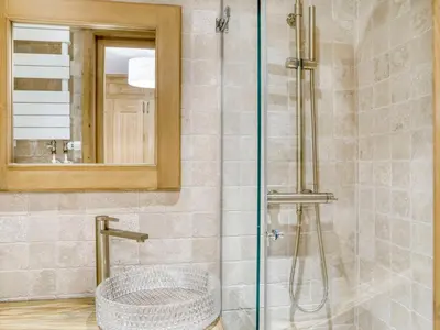 a bathroom with a shower with a sink and a mirror at Charmant appartement 2 chambres avec cheminée et parking à Megève - FR-1-453-254 in Megève