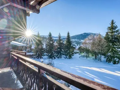 a view from a balcony of a snow covered yard at Charmant appartement 2 chambres à Megève avec Wifi et parking - FR-1-453-292 in Megève