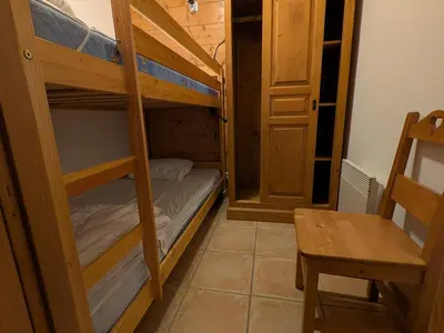 a large wooden building with snow in front of it at Charmant appartement 4 pièces 8 pers., ski au pied, animaux acceptés, wifi à Morillon - FR-1-815-86 in Morillon