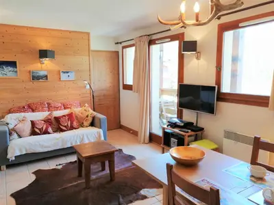 a living room with a bed and a table at Appartement 3 pièces, 6 personnes, proche pistes de ski, Wi-Fi - FR-1-815-87 in Morillon