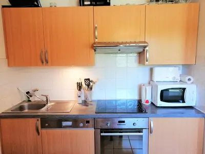 a kitchen and dining room with a table and chairs at Appartement 3 pièces, 6 personnes, proche pistes de ski, Wi-Fi - FR-1-815-87 in Morillon