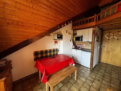 a small kitchen with a red table in a room at Studio 4 pers avec balcon, près des remontées mécaniques - FR-1-572-149 in Arâches-la-Frasse