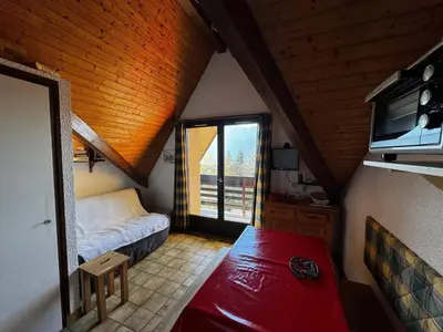 a attic room with a bed and a window at Studio 4 pers avec balcon, près des remontées mécaniques - FR-1-572-149 in Arâches-la-Frasse
