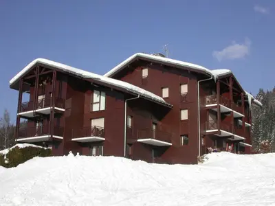a large brown building with snow on the ground at Studio spacieux 4 pers avec parking et lave-vaisselle - FR-1-572-93 in Arâches-la-Frasse