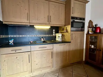 a kitchen with wooden cabinets and a sink at Appartement 3 pièces avec garage, terrasse, proche pistes et commerces à Arâches-la-Frasse - FR-1-572-250 in Arâches-la-Frasse