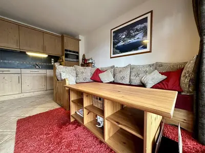 a living room with a couch and a wooden table at Appartement 3 pièces avec garage, terrasse, proche pistes et commerces à Arâches-la-Frasse - FR-1-572-250 in Arâches-la-Frasse