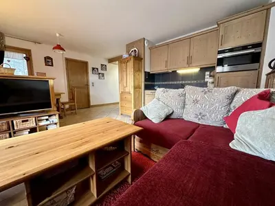 a living room with a couch and a flat screen tv at Appartement 3 pièces avec garage, terrasse, proche pistes et commerces à Arâches-la-Frasse - FR-1-572-250 in Arâches-la-Frasse