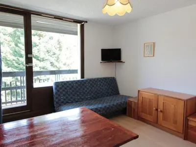 a living room with a couch and a table at Studio aux Carroz 4 pers, balcon, proche commerces et pistes - FR-1-572-254 in Arâches-la-Frasse